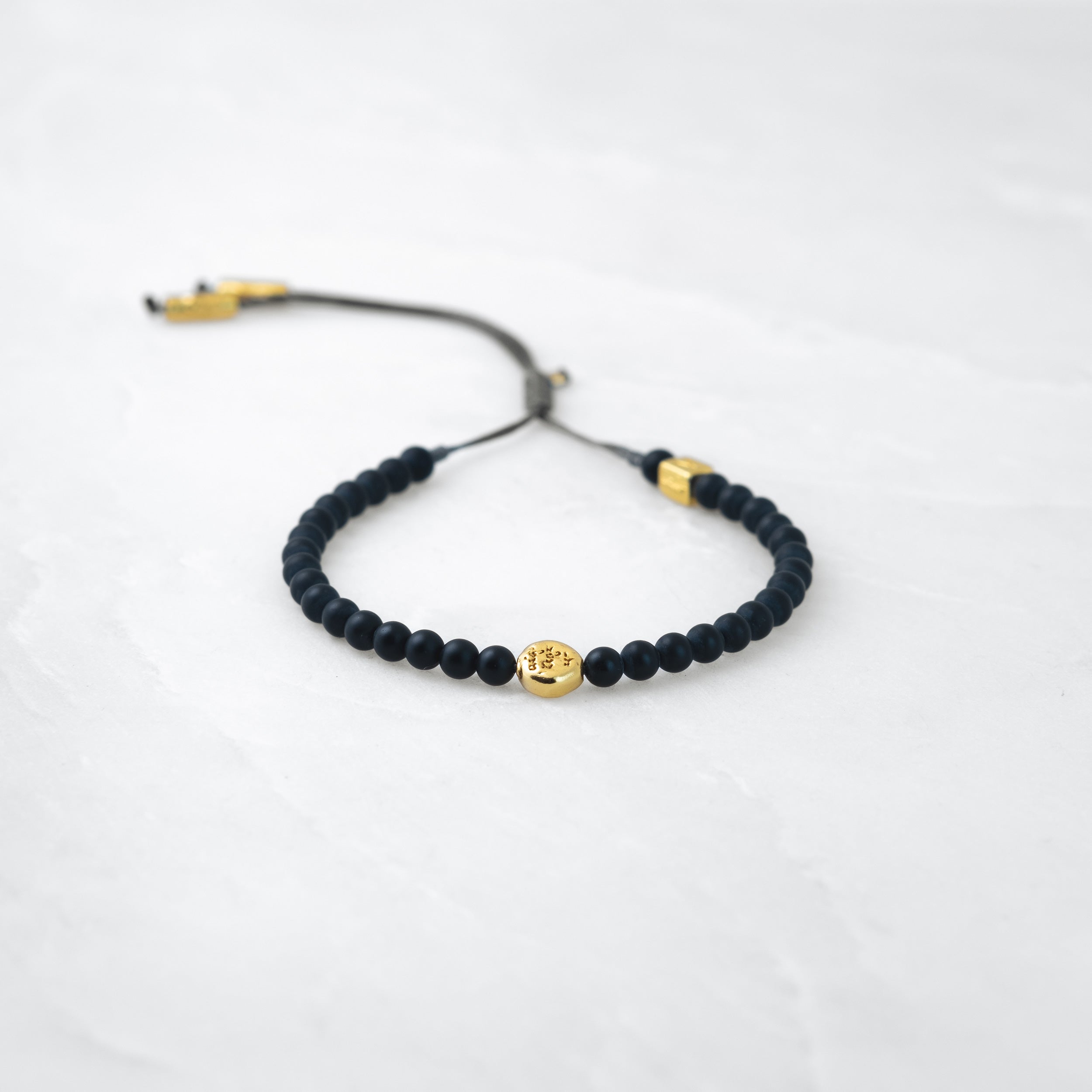 MALA bracelet - Basalt, golden Mani